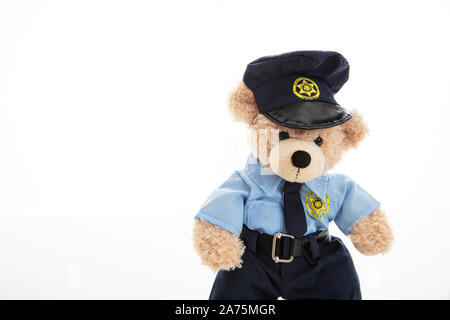 Police and security concept. Cute teddy bear in police officer uniform isolated against white background Stock Photo