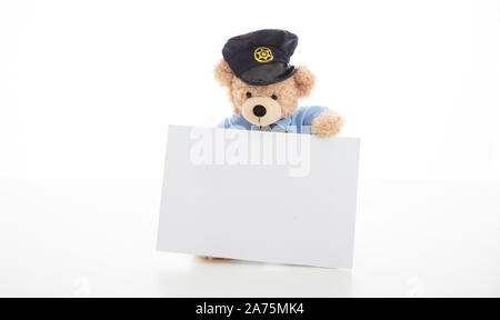 Police and security concept. Cute teddy bear in police officer uniform holding a blank card isolated against white background, copy space Stock Photo