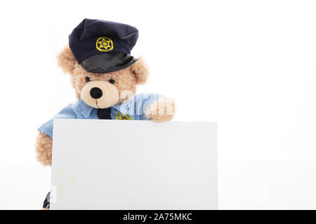 Police and security concept. Cute teddy bear in police officer uniform holding a blank card isolated against white background, copy space Stock Photo