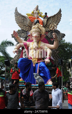 Mumbai, Maharashtra, India,  Asia - Procession Huge idols of lord Ganesh elephant-headed Hindu God Ganesha Transported by cart for Ganpati festival Stock Photo