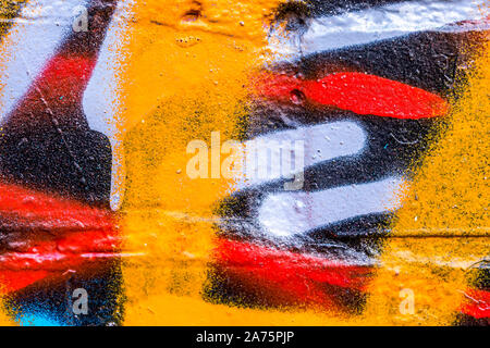 Fragment of colored graffiti painted on a brick wall. Abstract background for design. Stock Photo