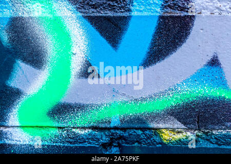 Fragment of colored graffiti painted on a brick wall. Abstract background for design. Stock Photo