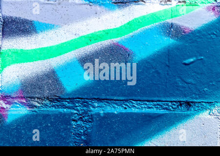 Fragment of colored graffiti painted on a brick wall. Abstract background for design. Stock Photo