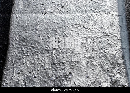 Fragment of silver graffiti painted on a wall. Abstract background for design. Stock Photo