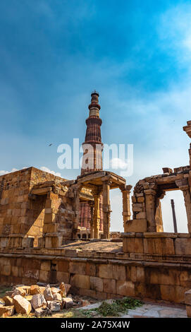 The Qutb Minar, also spelled as Qutab Minar or Qutub Minar and the ruined buildings Stock Photo