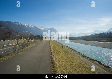 Standing on the river bank of the Rhine river in Lichtenstein Stock Photo