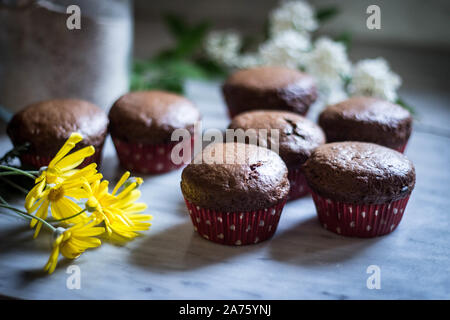 Still life food - Pastry - composition of muffins - with with flowers - selective focus Stock Photo
