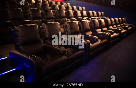 Empty cinema, cinema with soft chairs before the premiere of the film. There are no people in the cinema. Sliding automatic comfortable large leather Stock Photo