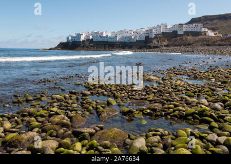 View of white house neighborhood of 'El Roque', Moya, on the island of Gran Canaria from a pebble beach. Spanish cityscape Stock Photo