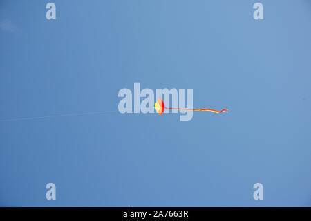 Kite flying in blue sky. Stock Photo