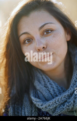 Young adult woman outdoors smiling and looking at camera Stock Photo