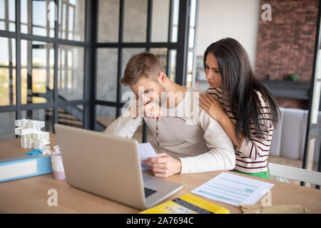 Husband feeling upset after filling tax declaration Stock Photo