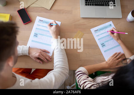 Top view of businessmen filling tax declarations sitting at the table Stock Photo