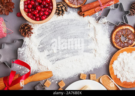 Christmas bakery. Ingredients for making cookies or gingerbread and spices on gray table, top view. Blank space for text. Stock Photo