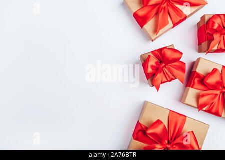 Frame of cardboard gift boxes with red bows. Stock Photo
