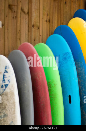 Rainbow multicolor surf boards and paddle boards top, available to hire in a shop in south west of France. Sports, exercice, holidays, ocean, beautifu Stock Photo