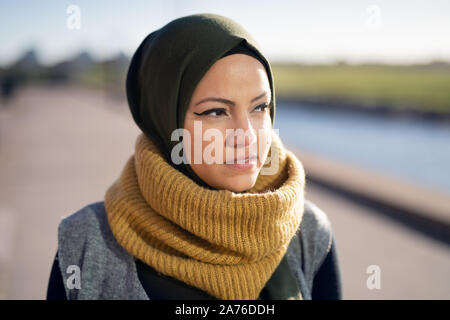 Portrait of a young woman wearing headscarf looking away Stock Photo