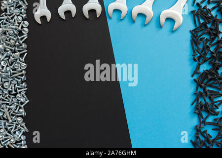 Flat Lay Composition With Different Construction Tools on Black Background. Top View of Checklist and Working Tools, Wrench, Screwdriver, Plier. Stock Photo