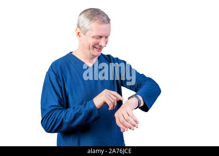 An elderly man measures the pulse of a fitness bracelet. Isolated on a white background. Stock Photo