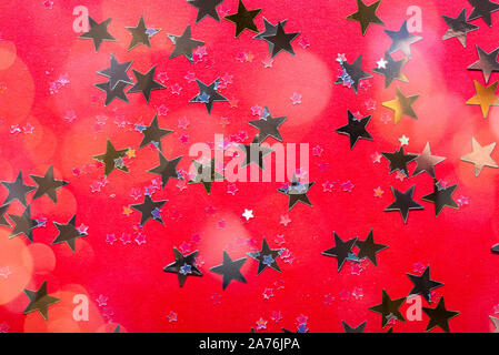 Gold stars on bright red background, abstract image Stock Photo