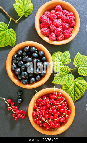 berries in bowl and on a table Stock Photo