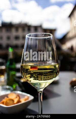 White wine on a wineglass on an outdoor terrace Italian wine Stock Photo