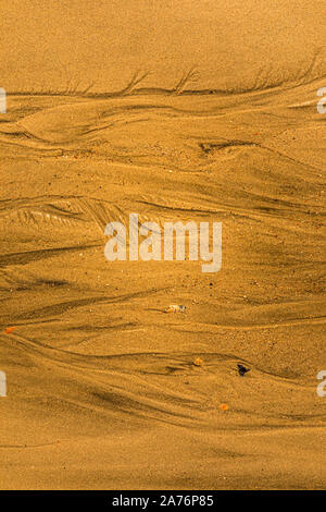 Close-up of sand with tidal ways and shells on the beach, full frame texture Stock Photo