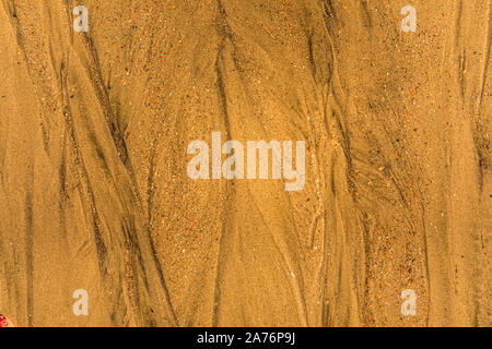 Close-up of sand with tidal ways and shells on the beach, full frame texture Stock Photo