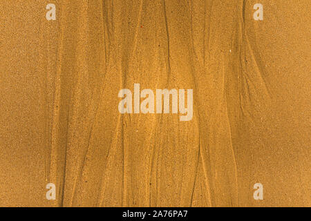 Close-up of sand with tidal ways and shells on the beach, full frame texture Stock Photo