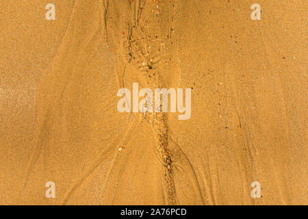 Close-up of sand with tidal ways and shells on the beach, full frame texture Stock Photo