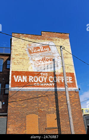 The Van Rooy Coffee Company historic building with its signature painted billboard on the side of the building in Cleveland, Ohio, USA Stock Photo