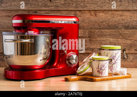 Locked stand mixer and two container jars for flour and sugar on a chopping board Stock Photo