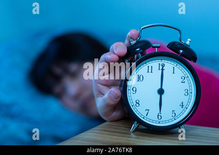 Daylight Saving Time woman waking up Stock Photo