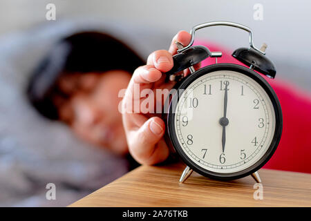 Daylight Saving Time woman waking up Stock Photo