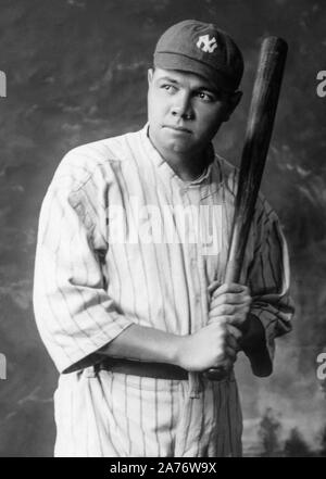 Baseball legend Babe Ruth (1895-1948) holding a baseball bat in a studio portrait, c1920. Stock Photo