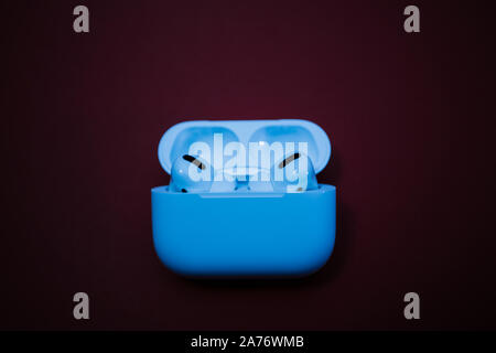 Paris, France - Oct 30, 2019: Blue color cast of the new Apple Computers AirPods Pro headphones with Active Noise Cancellation for immersive sound Stock Photo