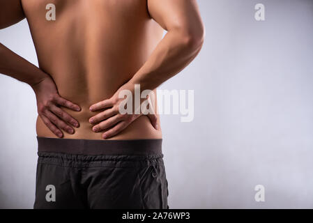 The man suffering from backbain on gray Stock Photo