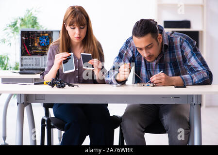 The two technicians working at computer warranty center Stock Photo