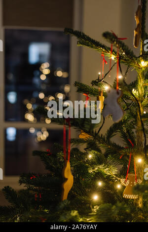 Christmas tree decorated with gingerbread cookies and garland Stock Photo