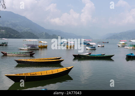 Phewa Lake a Cloudy Day and wooden color Boats Stock Photo