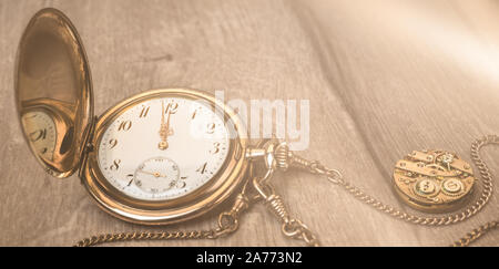 Vintage watch on a wooden background showing five to twelve, panoramic image with text space, Happy New Year! Stock Photo