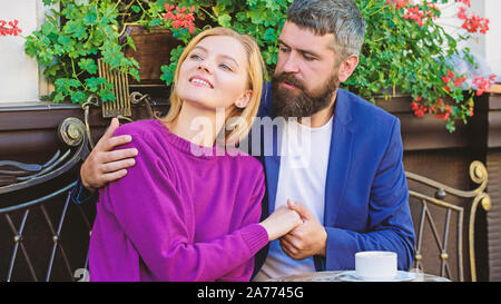 Pleasant family weekend. Married lovely couple relaxing together. Travel and vacation. Explore cafe and public places. Couple cuddling cafe terrace. Couple in love sit cafe terrace enjoy coffee. Stock Photo