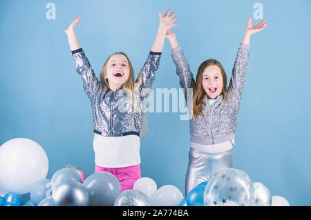 Start this party. Sisters organize home party. Having fun concept. Balloon theme party. Girls little siblings near air balloons. Birthday party. Happiness and cheerful moments. Carefree childhood. Stock Photo