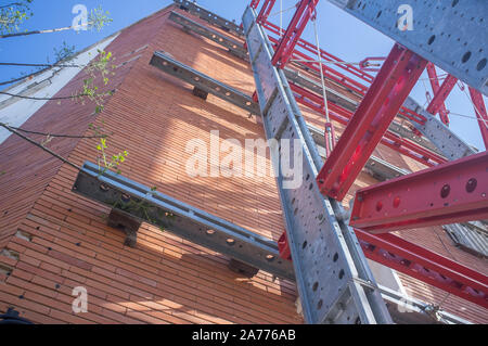 Reinforced building with structural bracing on facade. Steel girders detail Stock Photo