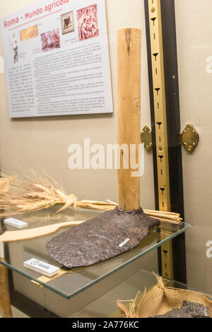 Montilla, Spain - March 2nd, 2019: Roman hoe. Agricultural iron tool with replica wooden handle and original narrow head. Montilla Local History Museu Stock Photo