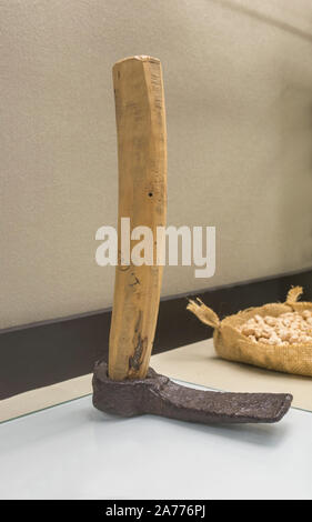 Montilla, Spain - March 2nd, 2019: Roman draw hoe. Agricultural iron tool with replica wooden handle and original head. Montilla Local History Museum, Stock Photo