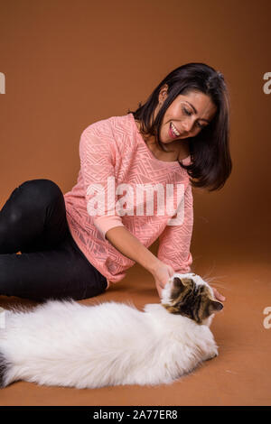 Portrait of beautiful multi ethnic woman with pet cat Stock Photo