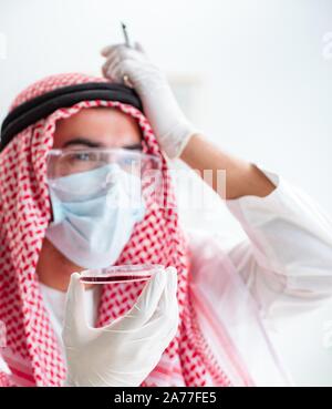 The arab doctor chemist studying new virus in lab Stock Photo