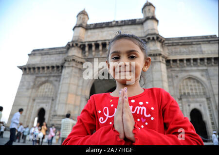 Mumbai, Maharashtra, India- Asia; Dec. 2011 -  Five Years Old Indian Little Girl in Welcome Posture Front of Gateway of India. Stock Photo