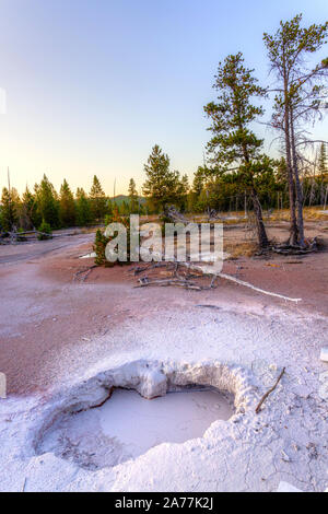 Sun setting over mudpot at Artists Paintpots in Yellowstone National Park, Wyoming, USA. Stock Photo
